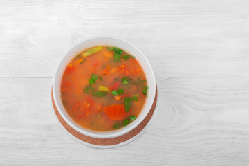 Vegetable soup with sliced carrots, peppers, tomatoes, beans and rice
