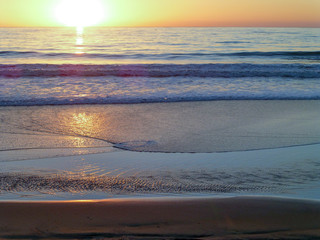 Sun setting over calm ocean