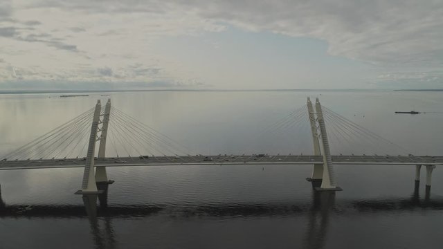 Drone view traffic on cable bridge over sea