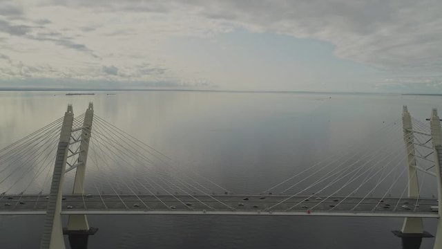 Aerial view traffic on Vant cable bridge in Saint-Petersburg, Russia. Drone flight backward