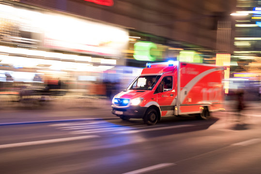 Rettungswagen der Berliner Feuerwehr f&auml;hrt mit Blaulich durch die Stadt