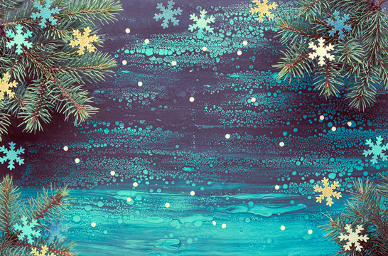 Festive Christmasr background with fir twigs and paper decorations on fluid art background, copy-space