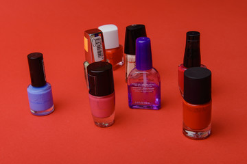 Coloured nail polish bottles on dark background