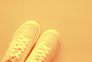 Sporty shoes on yellow background.