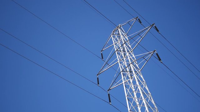 High-Voltage Tension Lines structure against blue sky