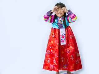 Asian little girl wearing a Korean Traditional Hanbok dress  in white background 