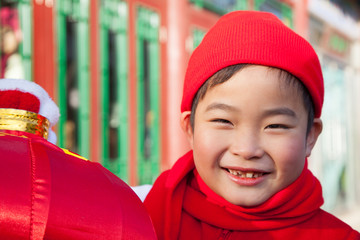 Boy holding lantern dressed in holiday attire