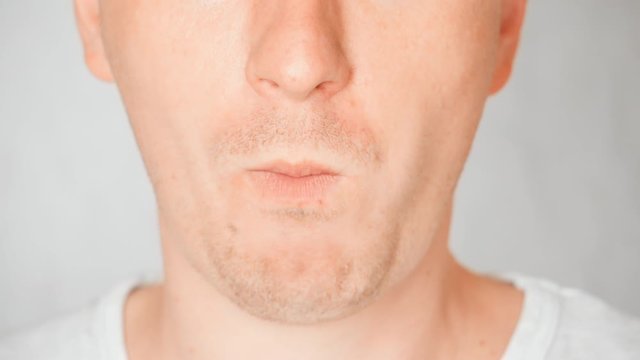lower face caucasian male eats cookies cream portrait guy bites and chews