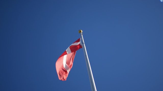 Denmark Flag blowing against clear blue sky background