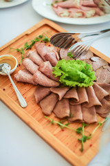 Close up delicious meat cutting on wooden plate on table in selective focus.