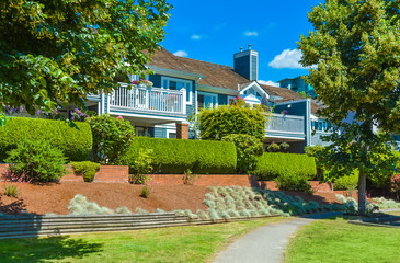 Beautiful attached houses on blue sky background in British Columbia, Canada.