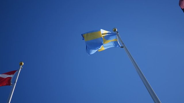 Swedish Flag blowing against clear blue sky background