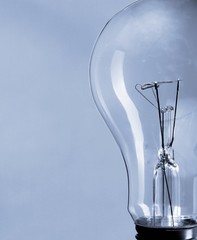Standard Incandescent Light Bulb on Blue Background