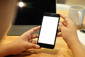 Cropped shot view of man hands holding smart phone with blank copy space screen for your text message or information content, female reading text message on cell telephone during in urban setting. 