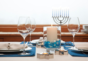 Dinner table setting decorated for Hanukkah Chanukah. Traditional Jewish holidays home celebrations...