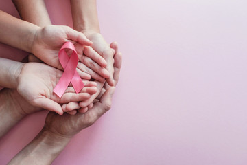 hands holding pink ribbons, Breast cancer awareness and October Pink day, world cancer day