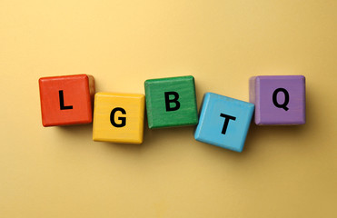 Obraz premium Cubes with abbreviation LGBTQ on color background