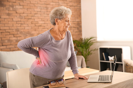 Senior Woman Suffering From Back Pain At Home