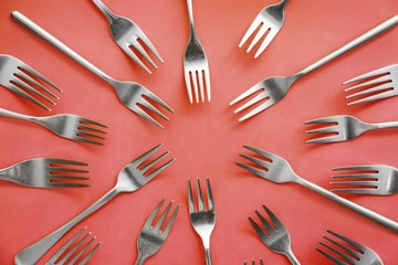 Set of forks on color background