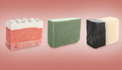 Different soap bars on color background