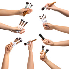 Female hands with makeup brushes on white background
