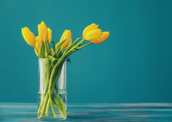 Vase with beautiful tulips on wooden table