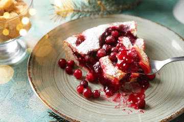 Piece of cranberry Christmas pie on fork over plate