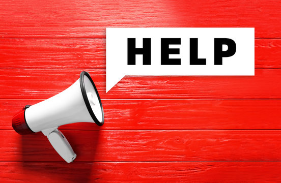 Megaphone on color wooden background