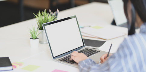 Close-up view of young businesswoman typing on laptop computer