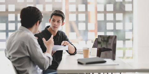Young freelancer team discussing their concept about the upcoming project together