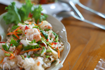 Eating Thai seafood spicy salad with shrimp and pork © bonnontawat
