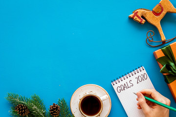 New Year goals concept. Notebook for writting resolution on blue background top view copy space
