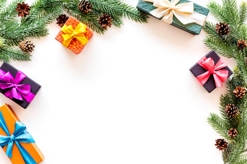Presents for christmas in boxes and spruce frame on white background top veiw copyspace