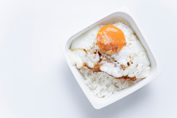 White rice box inside has fried egg and rice.