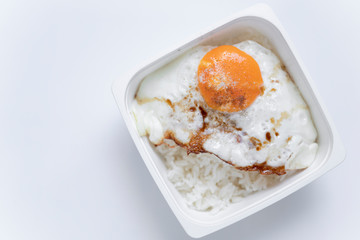 White rice box inside has fried egg and rice.
