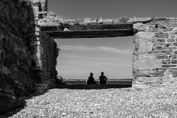 Two people sitting by the sea. Finister. Brittany. France