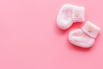 Booties for newborn girl on pink background top view mock up