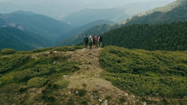 The flight above four active people on the mountain