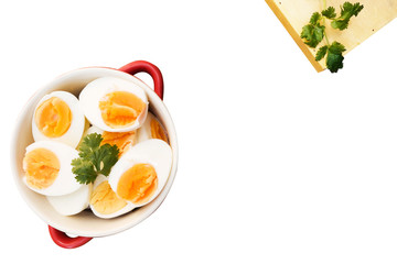 Boiled eggs cut in half, placed in a red bowl, on the tablecloth. clipping path