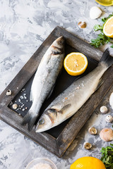 Fresh branzino fish with parsley, lemon and pink Himalayan salt
