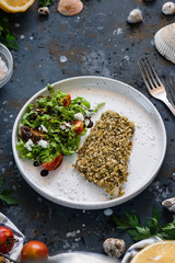Fish breaded with fresh salad. The concept of a balanced lunch or dinner. Proper nutrition. Tasty and healthy dish.