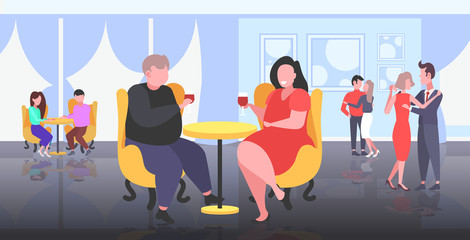 fat overweight couple sitting at cafe table obese man woman drinking wine unhealthy lifestyle obesity concept people having fun modern restaurant flat full length horizontal