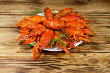 Boiled crayfish in plate on wooden table