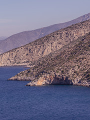 Summer time in Greece. Beautiful Greek coastline next to sea shore during warm weather.