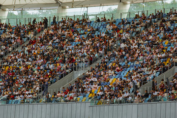 soccer stadium inside view. football field, empty stands, a crowd of fans, a roof against the sky © Yuliia
