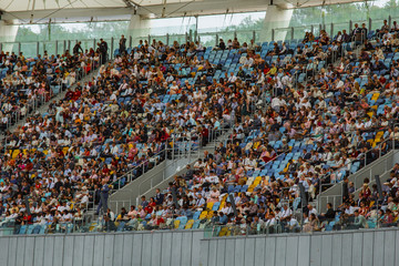 soccer stadium inside view. football field, empty stands, a crowd of fans, a roof against the sky