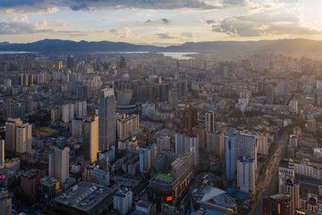 Kunming, China - September 13, 2019: Aerial view of Kunming at sunset with the Dianchi lake on background