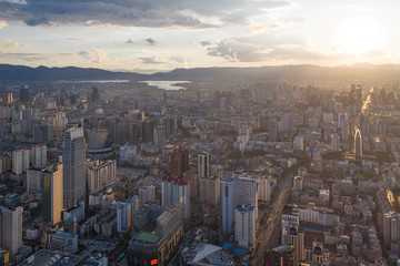 Kunming, China - September 13, 2019: Aerial view of Kunming at sunset with the Dianchi lake on background