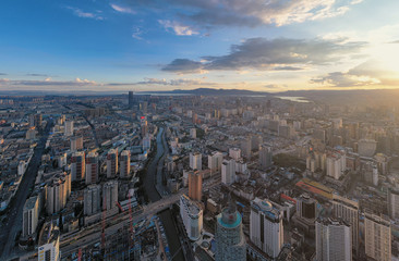 Kunming, China - September 13, 2019: Aerial view of Kunming at sunset with the Dianchi lake on background