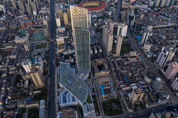 Kunming, China - September 13, 2019: Aerial view of Kunming at sunset with the Spring City 66 skyscraper and mall on foreground